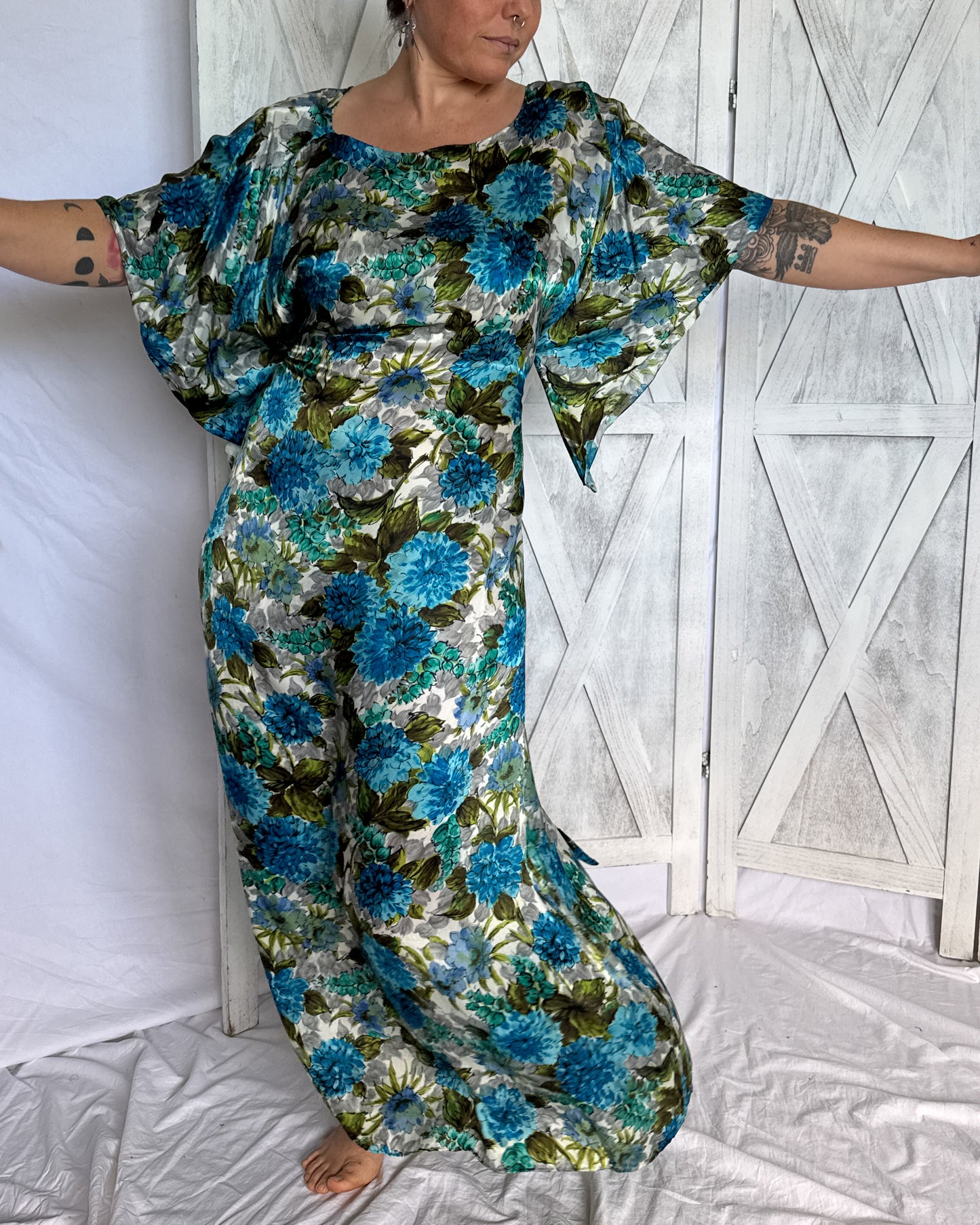 Close-up of 1960s hand-roller printed floral pattern in turquoise, chartreuse and grey on rayon challis