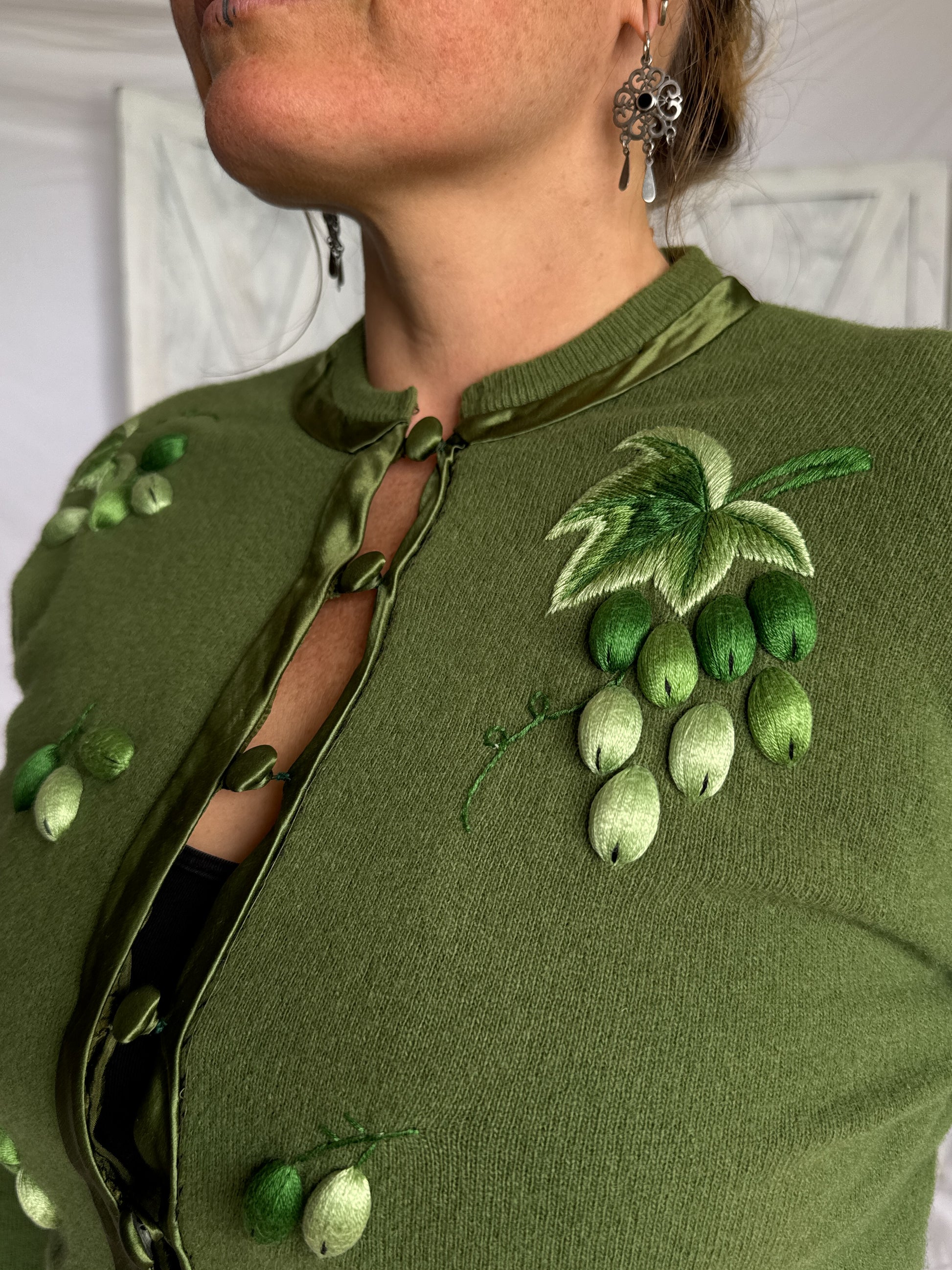 Green knit wool cardigan with grape embroidery detail